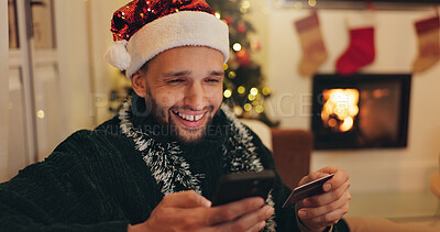 Buy stock photo Christmas, phone and happy man with credit card for online shopping, digital purchase or gifts order. Festive, holiday and person on smartphone for banking app, internet payment or ecommerce in home