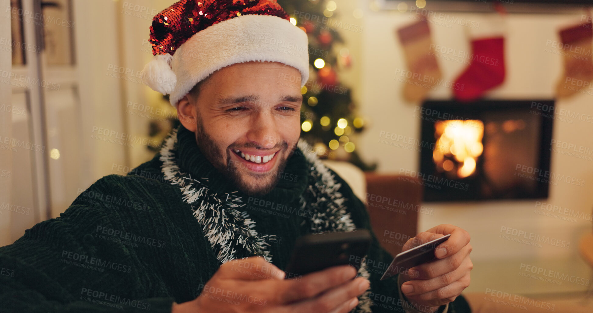 Buy stock photo Christmas, phone and happy man with credit card for online shopping, digital purchase or gifts order. Festive, holiday and person on smartphone for banking app, internet payment or ecommerce in home