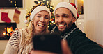 Christmas, happy and couple on video call in home for communication, talking and online chat. Love, selfie and man and woman on smartphone for memory of festive tradition, holiday wish and vacation