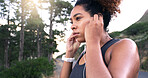 Woman, runner and earphones in road, nature and perspective with music, break and fitness training in summer. Girl, reflection and streaming for exercise, workout and sound by forest in Costa Rica