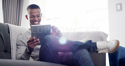 Buy stock photo Happy man, tablet and relax on sofa with comedy, streaming service and funny video in home. Male person, laugh and tech in living room for social media, viral meme and connectivity with ebook app