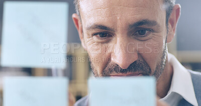 Buy stock photo Man, notes and planning by glass wall in office with reading, insight and review at media company. Person, board and thinking with mind map, process and project management  at insurance agency