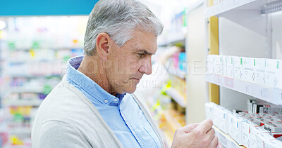 Buy stock photo Senior man, pharmacy and shopping by shelf with box, thinking and choice with medicine for wellness . Person, pills and decision with customer experience, product and reading  label at drugstore