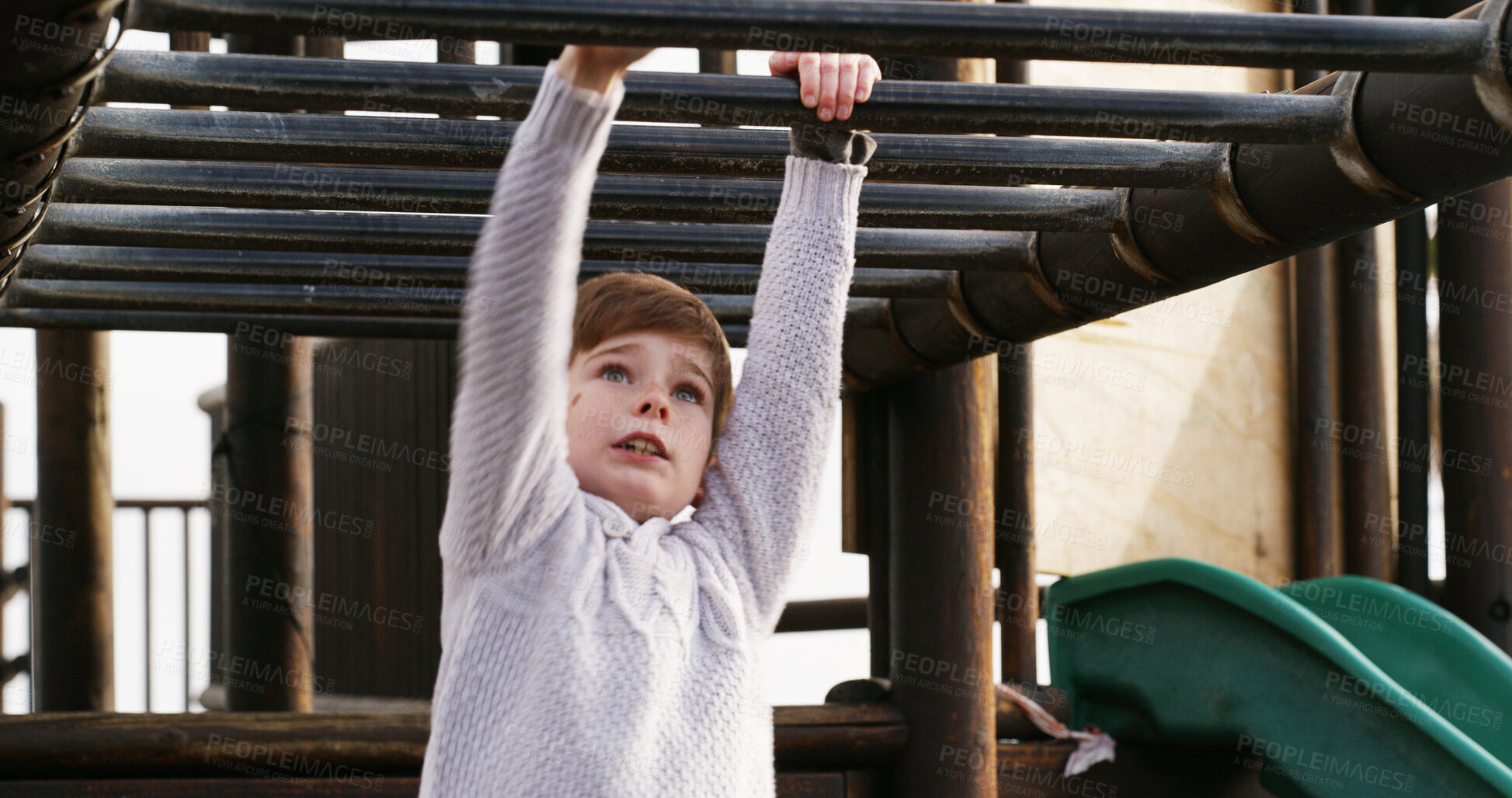 Buy stock photo Boy, child and outdoor on monkey bars at playground, swing or adventure with lifting, learning and balance. Kid, memory and exercise on jungle gym at park for challenge, climbing or sunshine in Spain