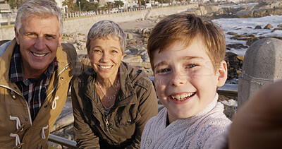 Buy stock photo Grandparents, boy and selfie at beach in portrait with memory, happy and bonding on holiday. Senior man, woman and child with photography, care and love with family on vacation with smile in Italy