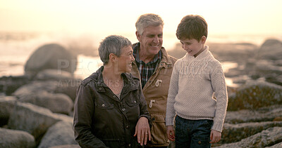 Buy stock photo Happy, ocean and grandparents laugh with child for bonding, fun weekend and relax together in nature. Morning, family and boy, grandpa and grandma on holiday, beach adventure and vacation at sunrise