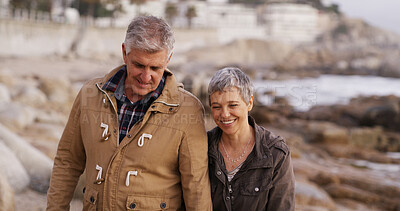 Buy stock photo Happy, holding hands and senior couple by ocean for bonding, relationship and love outdoors. Nature, marriage and man and woman by sea talking for romance, commitment and relax together on weekend