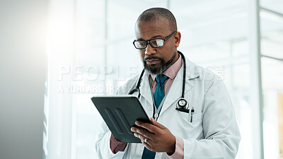 Buy stock photo Black man, surgeon and tablet for healthcare in hospital with medical research, Telehealth and surgery schedule. Male doctor, reading and digital for history report, patient information and diagnosis