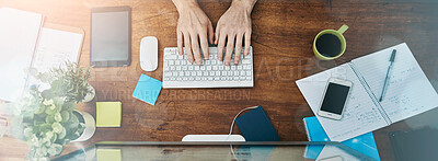 Buy stock photo High angle shot of an unrecognizable businessman working on his computer in the office