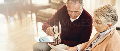 Buy stock photo Shot of an elderly couple working out a budget while sitting on the living room sofa