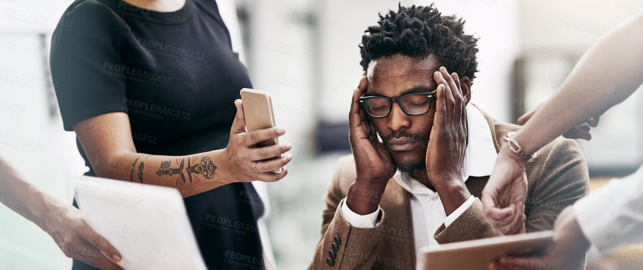 Buy stock photo Cropped shot of a stressed out businessman surrounded by colleagues needing help in an office