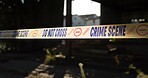 Crime scene, police tape and warning in building for investigation with safety caution, danger or evidence. Forensic inspection, barrier sign and no entry in abandoned garage for emergency and search