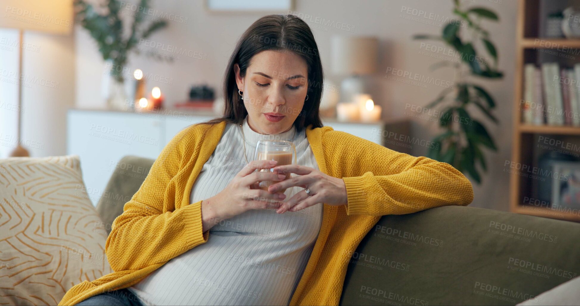 Buy stock photo Coffee, relax and thinking with pregnant woman, sofa and living room of home for maternity leave wellness. Break, warm drink and mother blowing with glass, apartment and comfort for pregnancy or rest