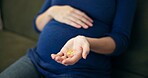 Pills, healthcare and hands of pregnant woman on sofa for prenatal vitamins, medicine and prescription. Wellness, folic acid and supplements with person at home for baby, growth and pregnancy