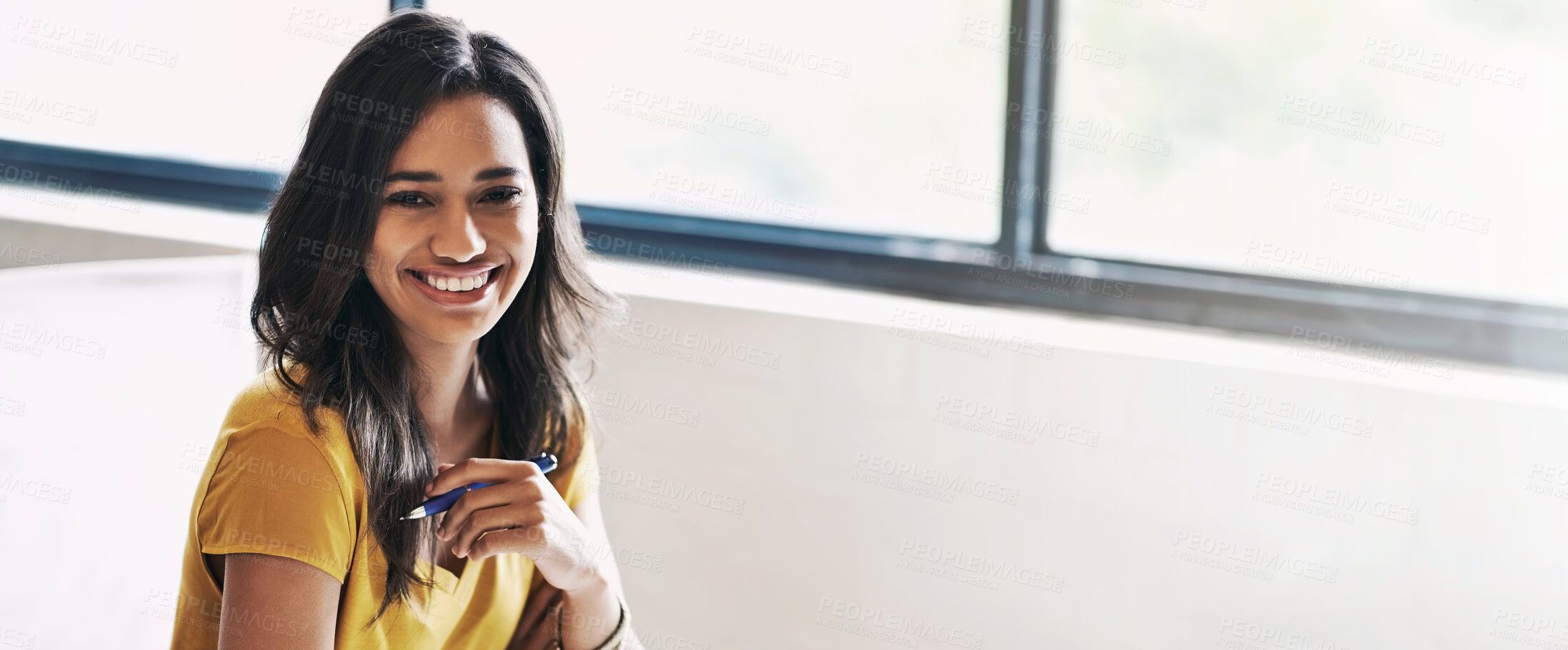 Buy stock photo Shot of a young designer sitting at her desk