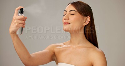 Buy stock photo Woman, studio and makeup with setting spray for beauty, glow and cosmetics on gray background. Female person, beautician and eyes closed with face mist for application, foundation and blending