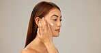 Cosmetics, profile and woman with cream, skincare and dermatology on gray studio background. Person, model and girl with shine, moisturise and aesthetic with creme, healthy skin and grooming routine
