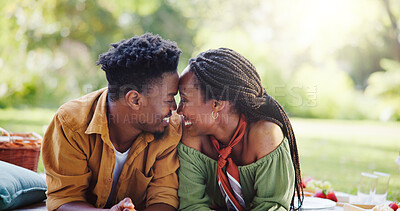 Buy stock photo Love, touch and happy black couple at picnic in park for bonding, connection and outdoor adventure on weekend. Nature, man and woman on grass for date together with romantic embrace, smile and garden