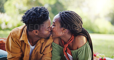 Buy stock photo Love, kiss and black couple at picnic in park for bonding, connection and outdoor adventure on weekend. Nature, man and woman on grass for romantic date together with passionate embrace in garden