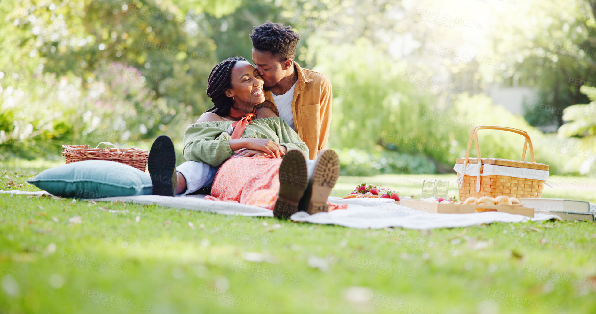 Buy stock photo Kiss, relax and love with black couple and picnic for bonding, happiness and romantic date. Smile, support and conversation with man and woman at park for commitment, valentines day and summer