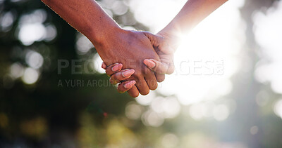 Buy stock photo Couple, forest or holding hands with sunshine for support, hope or bonding together in nature. Closeup, man or woman with touch, connection or love for commitment, holiday or outdoor weekend in woods