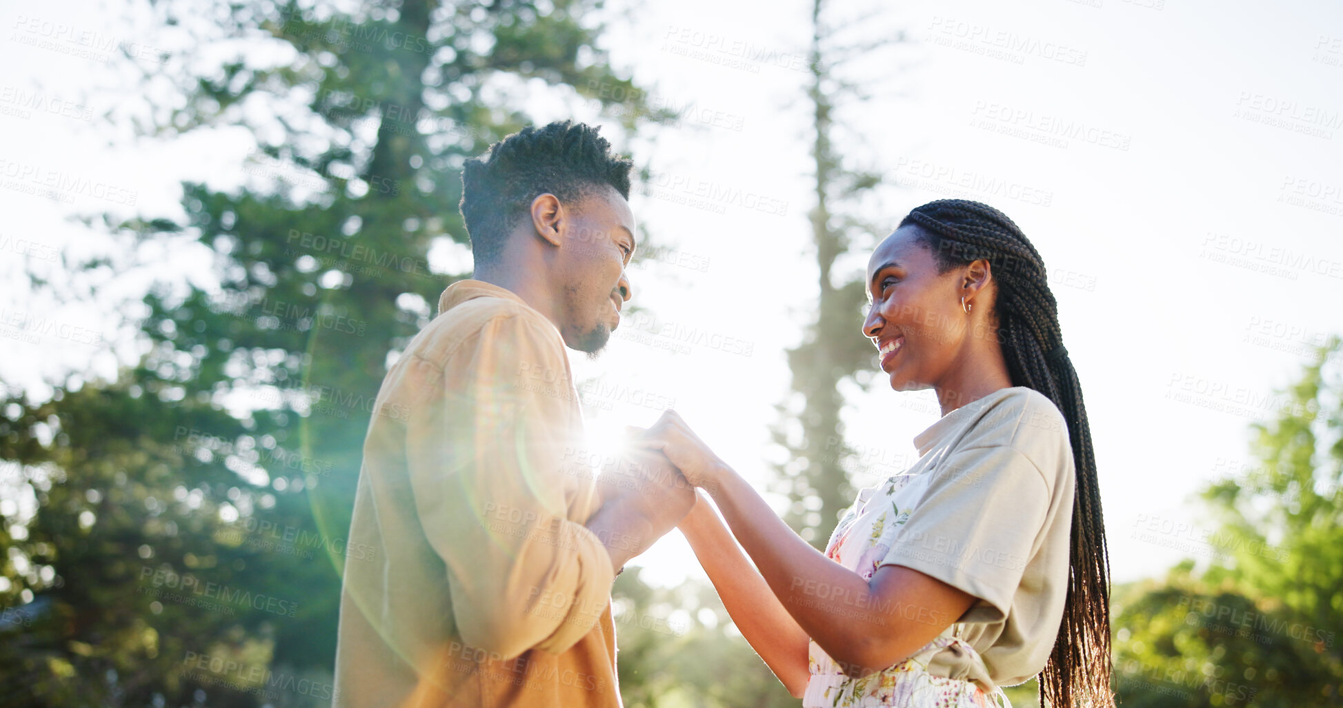 Buy stock photo Happy, love and black couple in park holding hands together for bonding, relationship and affection in nature. Relax, dating and man and woman outdoors for romance, holiday and commitment on weekend