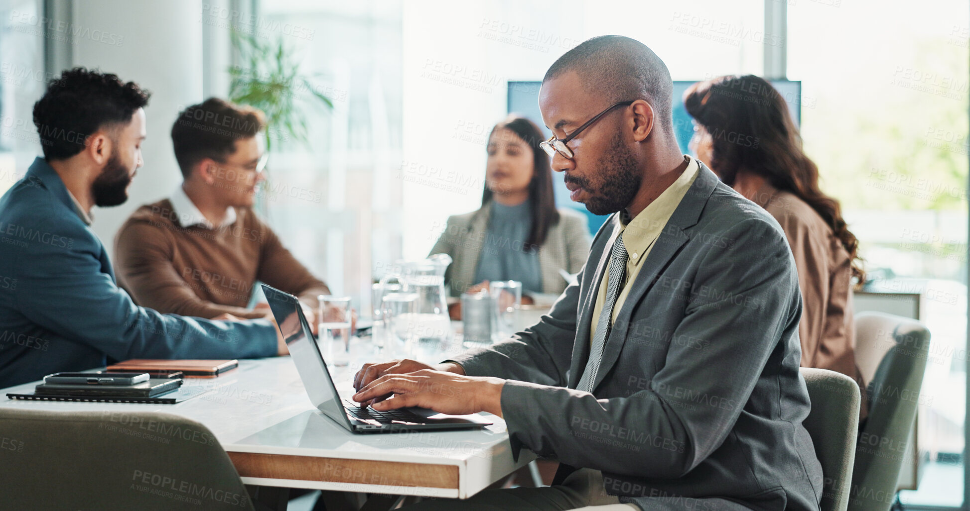 Buy stock photo Business man, laptop and research in meeting with project administration, proposal and planning in office. Manager, tech and diversity with typing report for discussion, feedback and communication