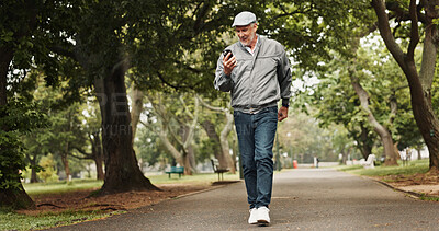 Buy stock photo Senior man, walking and park with phone for good news, communication or happy day in nature. Excited, mature or male person with smile on mobile smartphone for online browsing or outdoor stroll