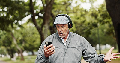 Buy stock photo Headphones, senior man and surprised with phone in park for good news, giveaway winner and gambling bonus. Old person, smartphone and shocked for lottery prize, competition notification and shouting