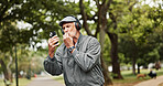 Headphones, senior man and phone for winning in park with good news, online giveaway and gambling bonus. Old person, smartphone and satisfaction for lottery prize, competition notification or success