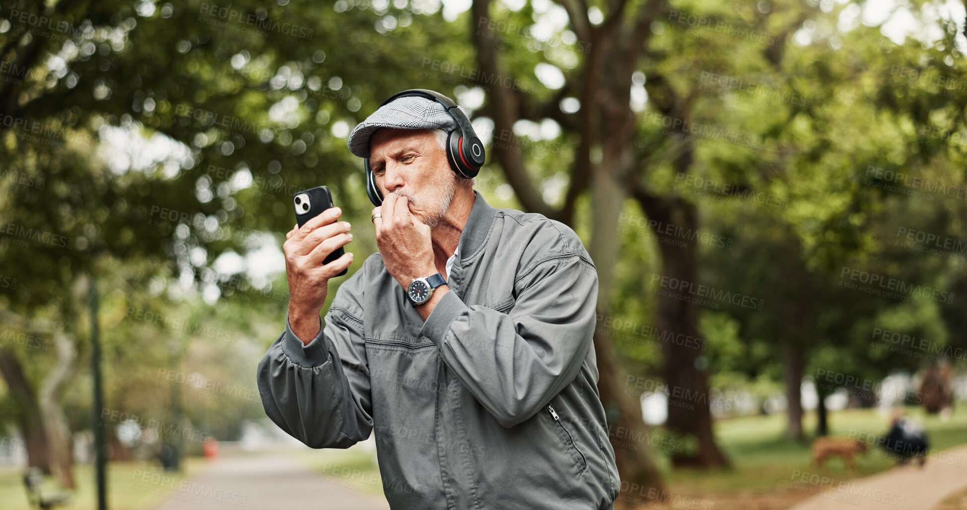 Buy stock photo Headphones, senior man and phone for winning in park with good news, online giveaway and gambling bonus. Old person, smartphone and satisfaction for lottery prize, competition notification or success
