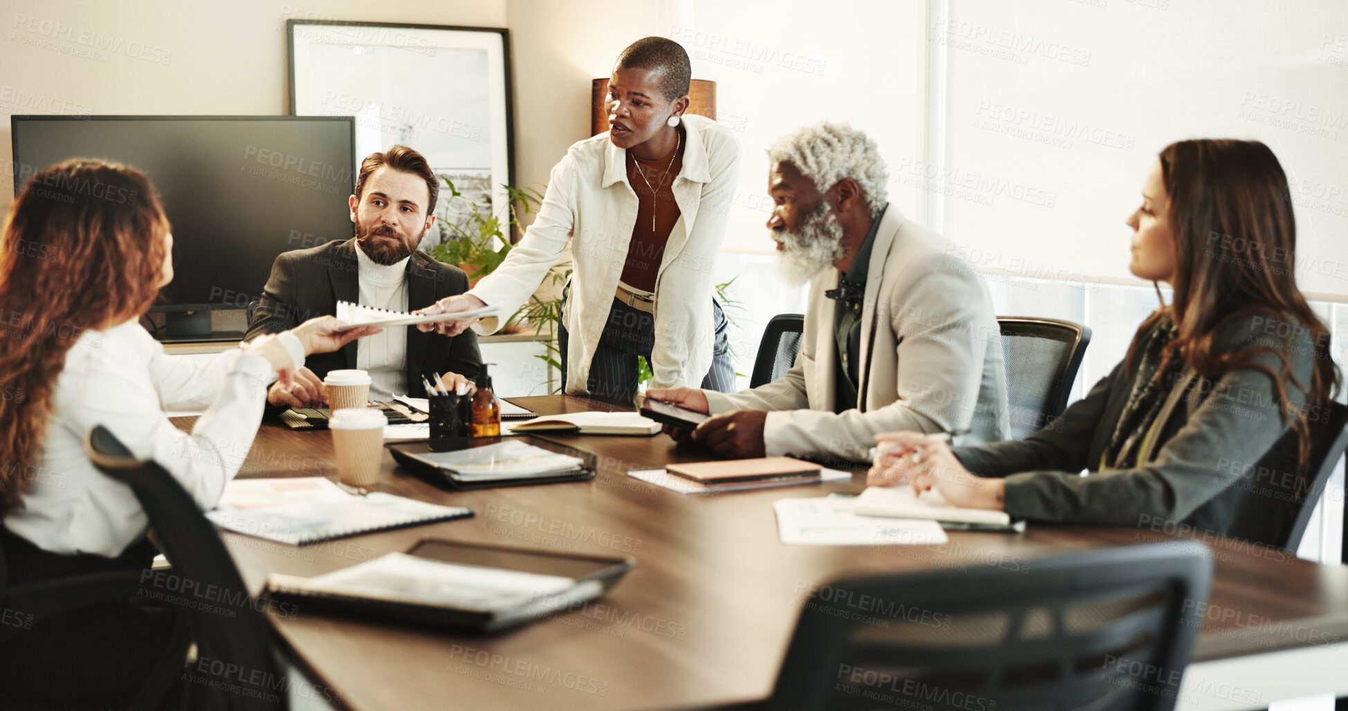Buy stock photo Documents, handout and meeting with business people in boardroom of office for coaching or training. Collaboration, diversity and workshop with professional employee group in corporate workplace