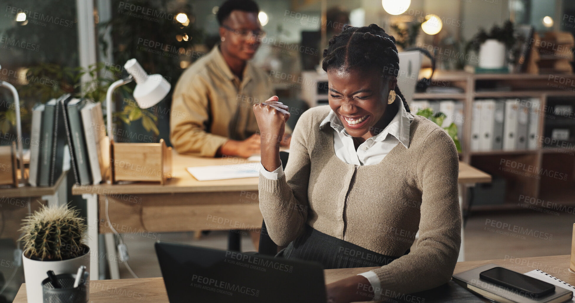 Buy stock photo Excited, black woman and night with laptop for winning, celebration or promotion at office desk. Happy African, female person or winner with smile on computer for victory or good news at workplace