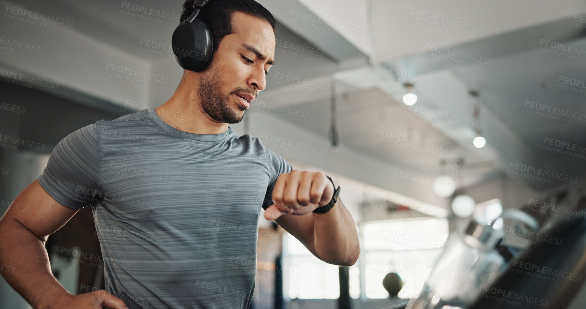 Buy stock photo Fitness, gym and man with time, music and heart rate check with treadmill and runner stats. Stopwatch, run and wellness app with exercise, training and pulse tracking for workout with monitor tech