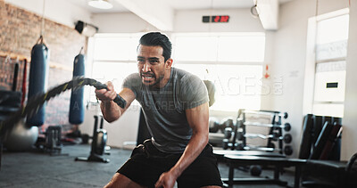 Buy stock photo Exerciser, battle rope and man in gym for bodybuilding training, fitness and intense workout. Sports, athlete and person with weightlifting equipment for muscle strength, performance and challenge