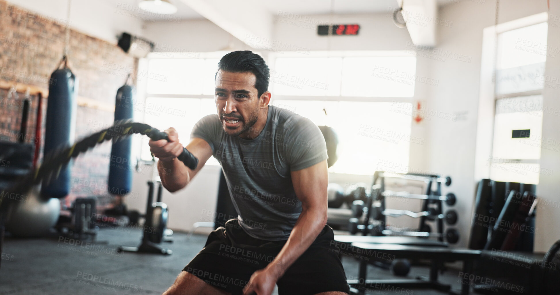 Buy stock photo Exerciser, battle rope and man in gym for bodybuilding training, fitness and intense workout. Sports, athlete and person with weightlifting equipment for muscle strength, performance and challenge