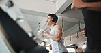 Man, running and headphones with treadmill for cardio workout, exercise or training at gym. Active, male person or runner with headset for music, listening or podcast in fitness at indoor health club