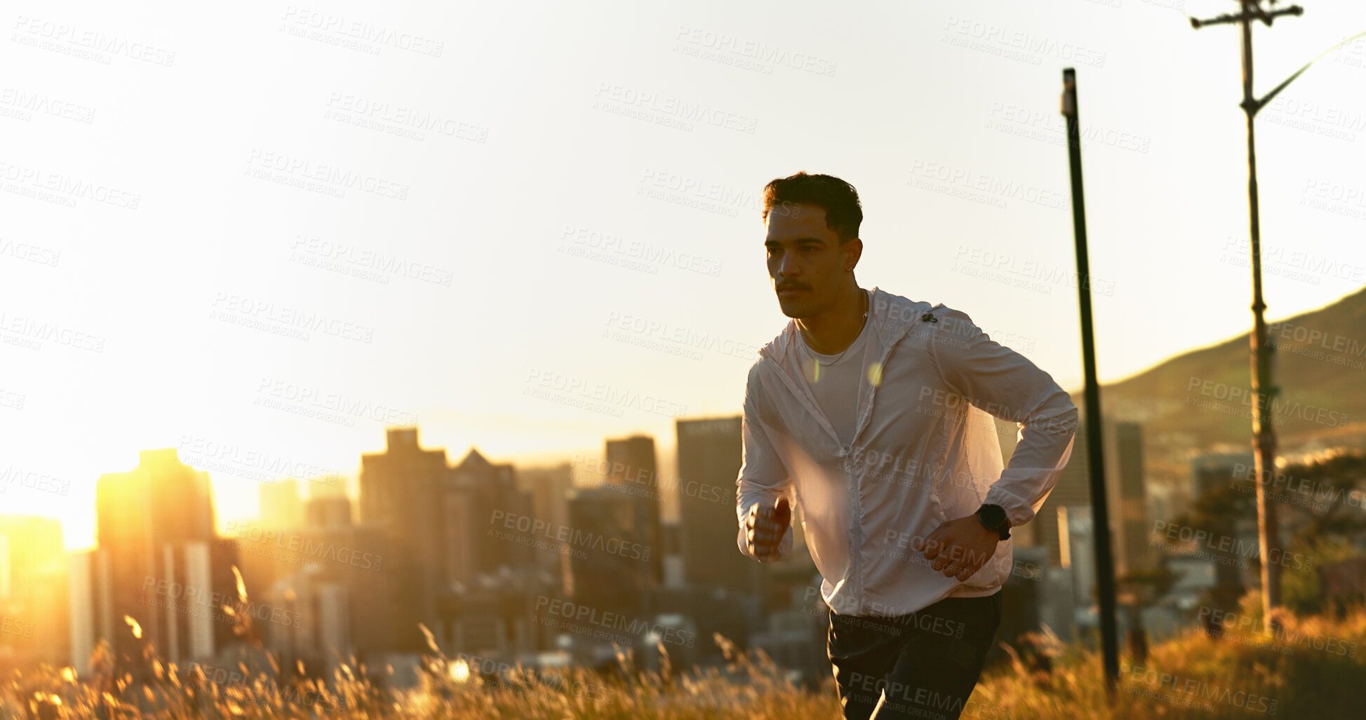Buy stock photo Man, runner and sunset with exercise, training and city for fitness or cardio workout. Athlete, person and countryside on mountain for wellness, health and summer marathon performance or endurance