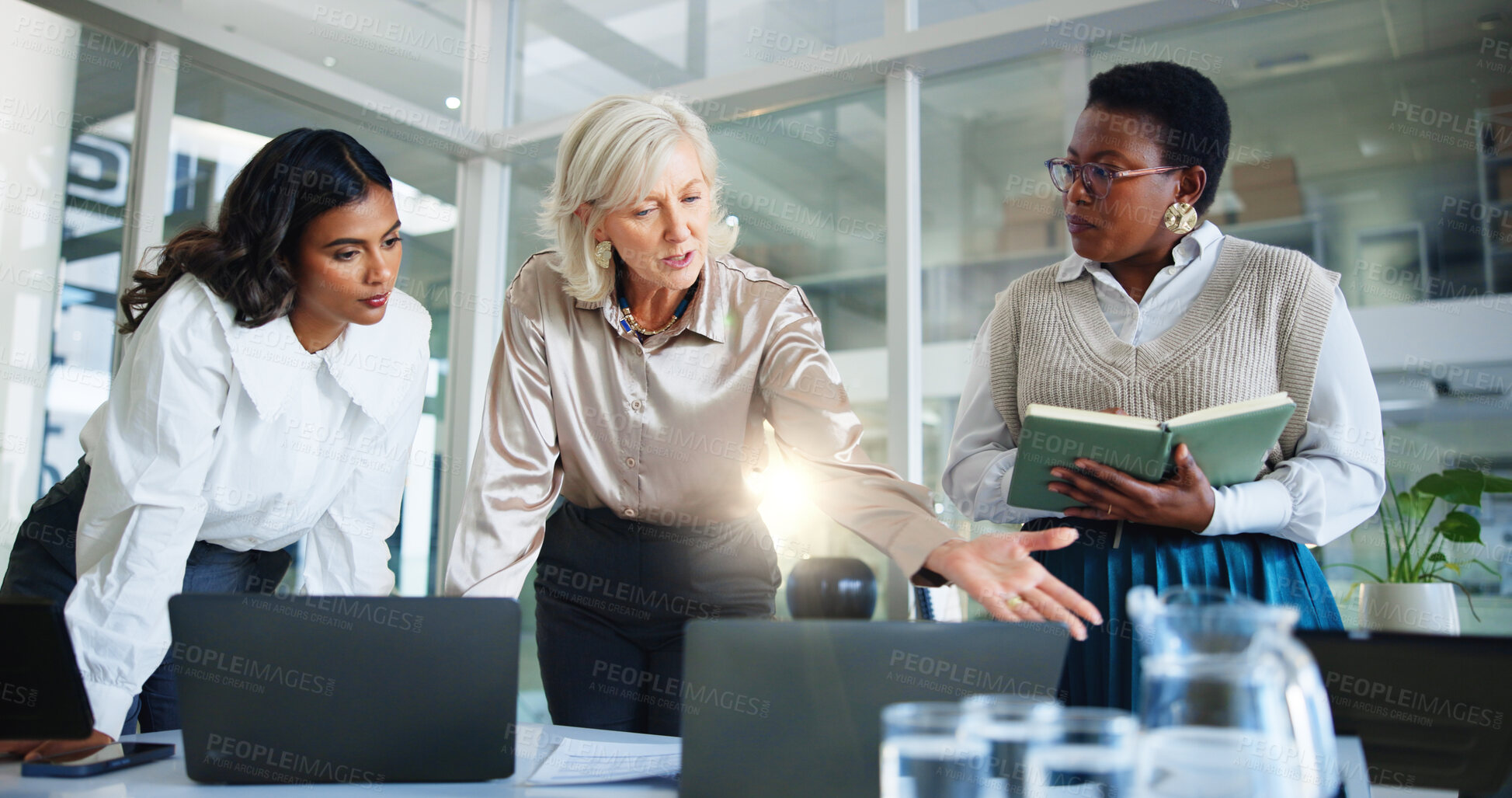 Buy stock photo Business women, coach and meeting with laptop for project management or discussion at office. Female people, employees or colleagues listening to mentor for job insight or staff training at workplace