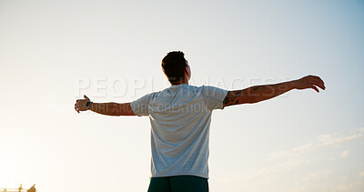 Buy stock photo Man, back and breathing with blue sky on beach for peace, health and wellness by sea in nature. Male person, athlete and arms out for freedom, breeze or natural fresh air with fitness on ocean coast