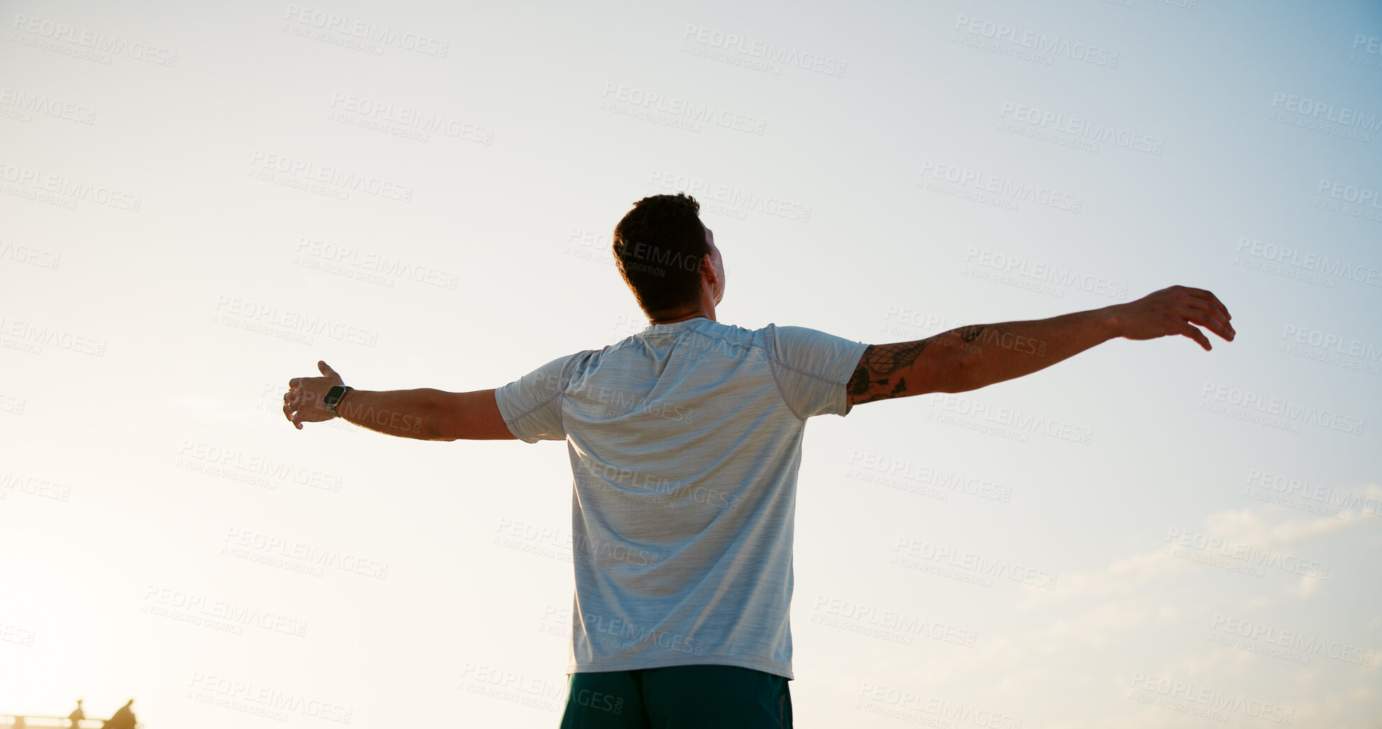 Buy stock photo Man, back and breathing with blue sky on beach for peace, health and wellness by sea in nature. Male person, athlete and arms out for freedom, breeze or natural fresh air with fitness on ocean coast