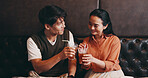 Japanese, couple and drinks in restaurant for cheers, anniversary celebration or love in relationship. Valentines day, man or woman with glasses for beverage, connection or bonding with toast on date