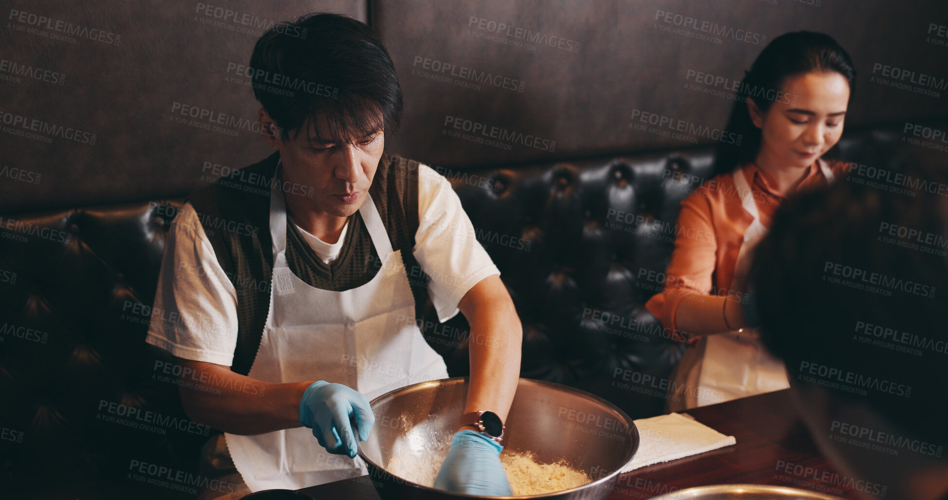 Buy stock photo Cooking, man and woman in class with chef, romantic date and bonding together at Asian food restaurant. Couple, learning and making noodles at cafe with teacher, culinary course and Japanese culture