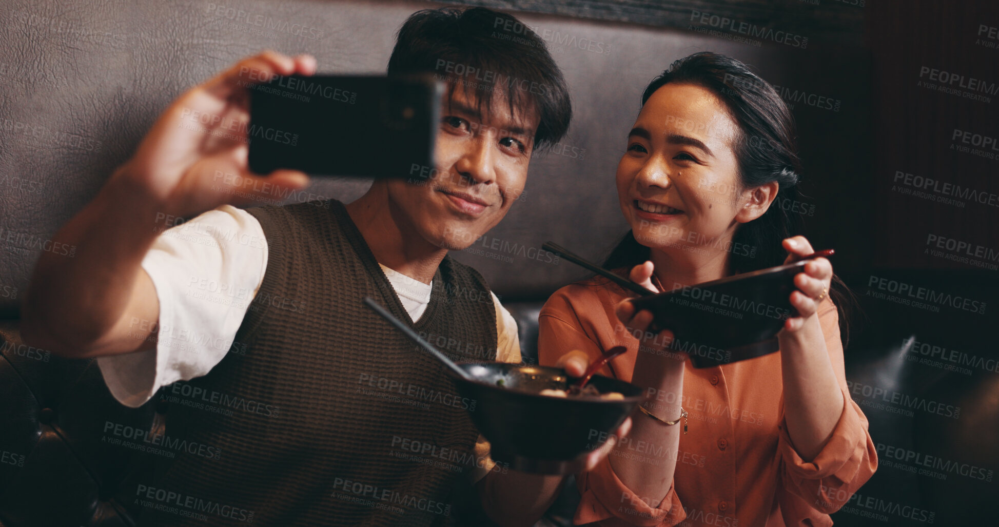 Buy stock photo Couple, food and selfie on date in restaurant for happy memory, profile picture update or social media post. Japanese people, ramen bowl and smile with photography in cafe for bonding and nutrition