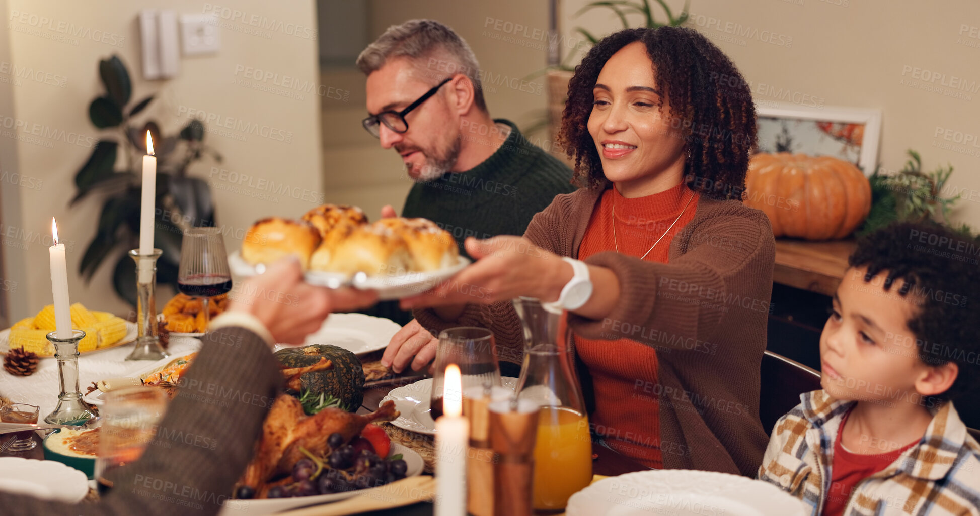 Buy stock photo Happy family, serving and thanksgiving dinner with kids, festive holiday and food for vacation. Feast, people and interracial parents at party, reunion and gathering for celebration or event in home