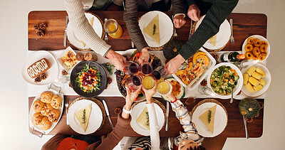 Buy stock photo Above, cheers and thanksgiving with family and drink for celebration, toast and festive holiday. Catering, wine and reunion with food and people at home for dinner, hosting and healthy meal together