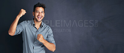 Buy stock photo Yes, motivation and portrait of man with fist, winning and excited announcement in studio. Celebration, banner and happy from offer and giveaway with mockup space and champion with grey background