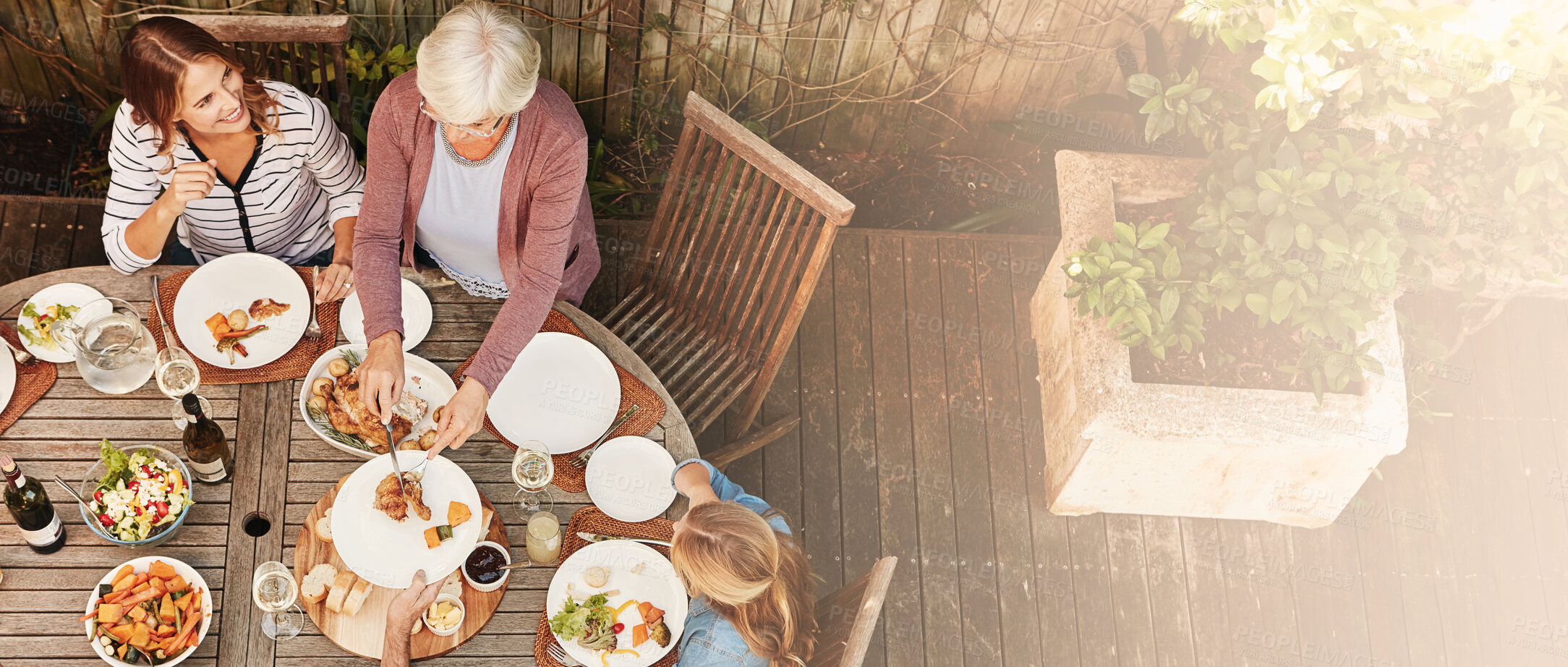 Buy stock photo Thanksgiving, celebration and above family with food, lunch together and home backyard. Grandmother, woman and child ready to eat chicken on holiday, festival and vacation for tradition and bonding