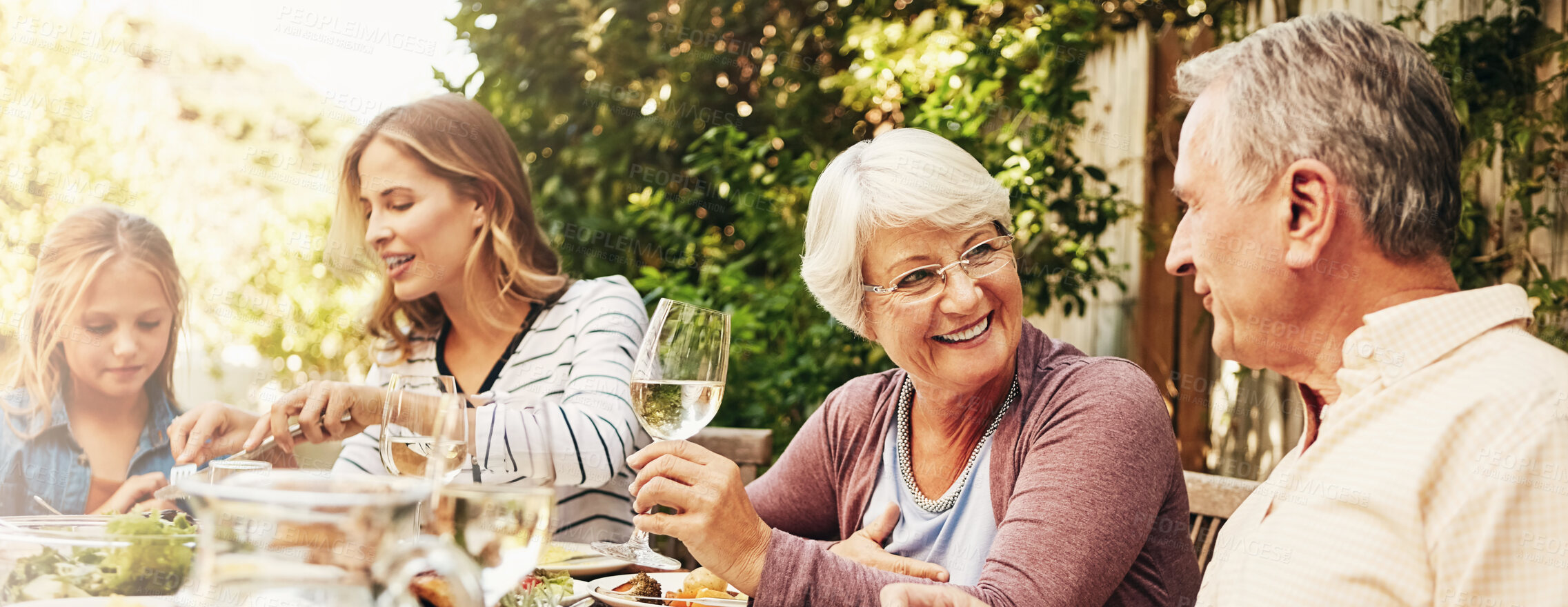 Buy stock photo Grandparents, mother and child in backyard for lunch, eating and share meal together in garden. Family, banner and people at table with food for bonding at Thanksgiving, Christmas and festive party