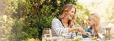 Buy stock photo Help, mother and child at outdoor lunch with smile, thanksgiving and family eating together in backyard. Care, mom and daughter at table for garden picnic with food, happy bonding and love on banner